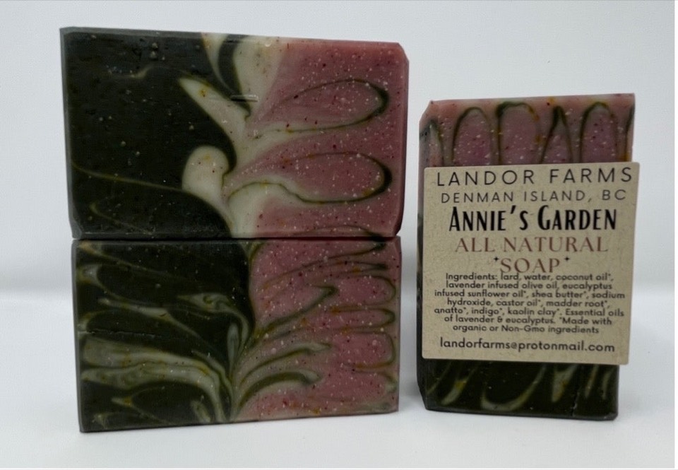 Annie's Garden soap bars, dark green and pink with cream feather swirls, one wearing a Landor Farms kraft label